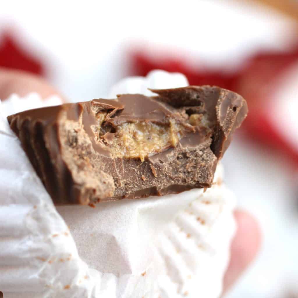 Healthy and Delicious Chocolate Peanut Butter Cups with a bite taken out of it